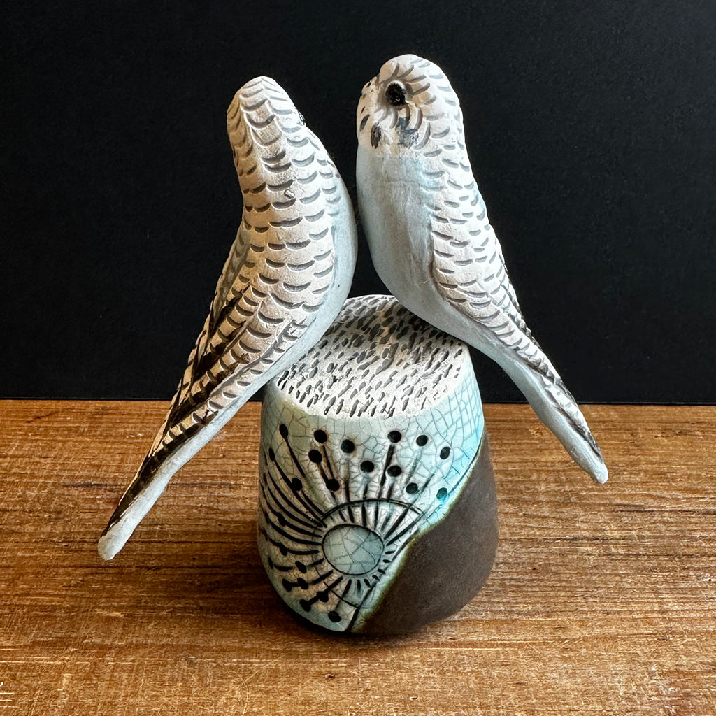 Pair of Small Blue Budgies on a Plinth