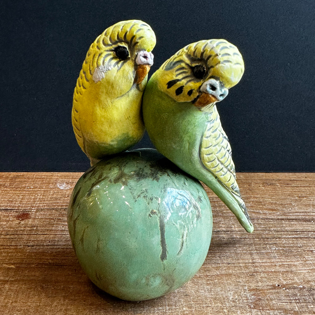Two Medium Green Budgies on a Ball