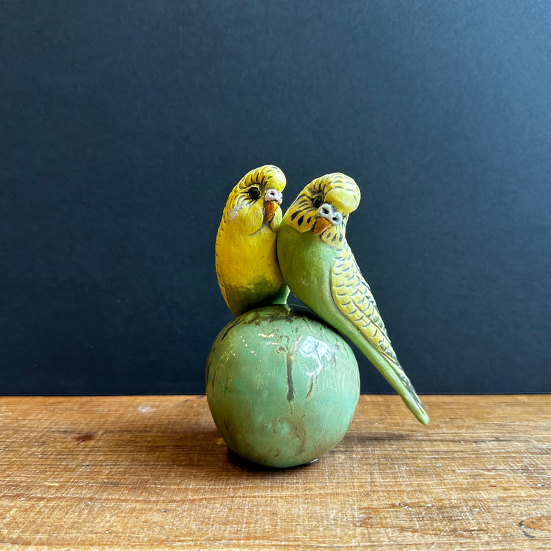 Two Medium Green Budgies on a Ball