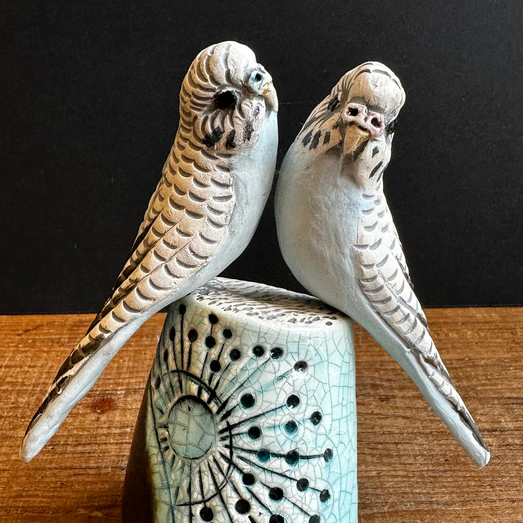 Pair of Small Blue Budgies on a Plinth